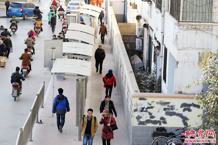 墻內(nèi)扔著垃圾，墻面上涂滿了牛皮癬小廣告，異常顯眼。