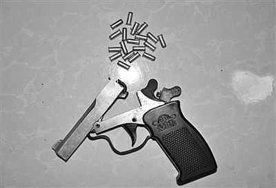 警方從搶劫嫌疑人處起獲的贓款和發(fā)令槍、子彈。警方供圖