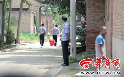 昨日，西安市閻良區(qū)譚家村，警方在事發(fā)的孫某家里勘查現(xiàn)場后，將提取的物證帶走 記者 黃利健 攝