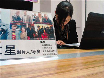 4月17日，西土城錦秋家園面試點(diǎn)，工作人員在為招聘者填寫材料，桌上擺著公司負(fù)責(zé)人李仁星與甄子丹、李連杰等明星合影。