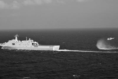11日，抵達(dá)馬航飛機(jī)失聯(lián)海區(qū)的海軍井岡山艦與艦載直升機(jī)協(xié)同展開立體搜救行動(dòng)。新華社發(fā)