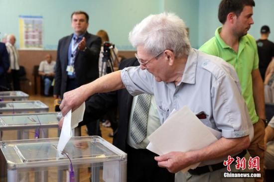 　5月25日，一名烏克蘭選民把填好的選票投入選票箱。