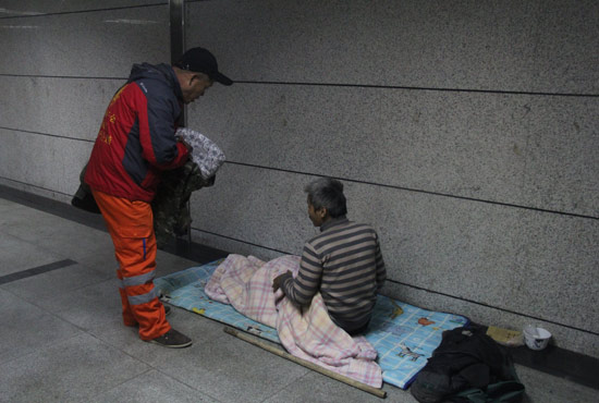 在鄭州一處地下通道，孫德坤挑了幾件衣服送給了流浪者