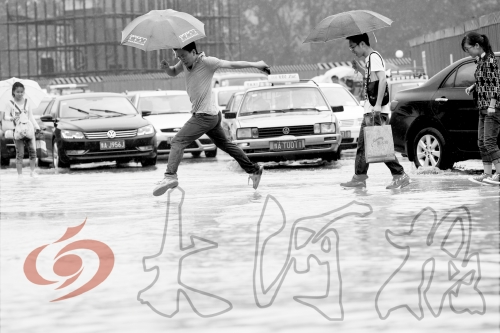 鄭州經(jīng)三路與北環(huán)交叉口處，積水較深，行人們不得不“練輕功”。 記者 白周峰 攝影