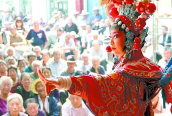 圖為8月15日戲曲演員在“流動(dòng)舞臺(tái)車”上表演傳統(tǒng)地方戲《穆桂英下山》。