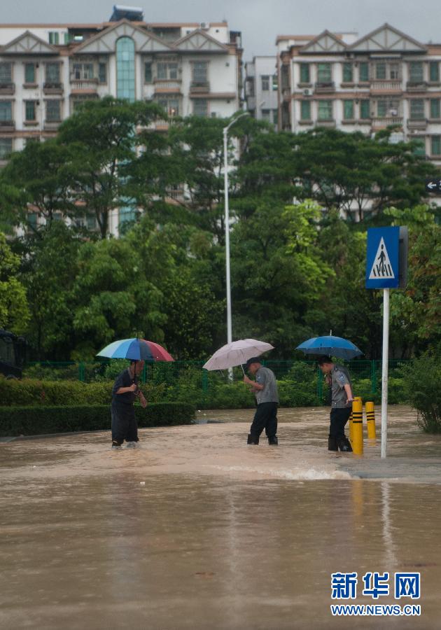5月11日，人們在深圳西麗涉水行走。