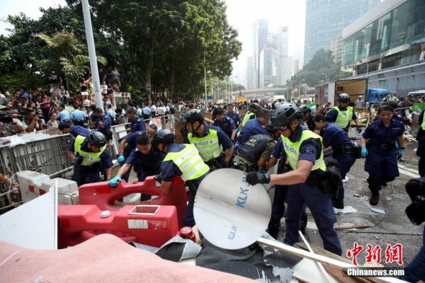 10月14日，警方清除金鐘道障礙物。大批警員在金鐘道現(xiàn)場(chǎng)清拆障礙物。部分警員戴上頭盔將障礙物移走。