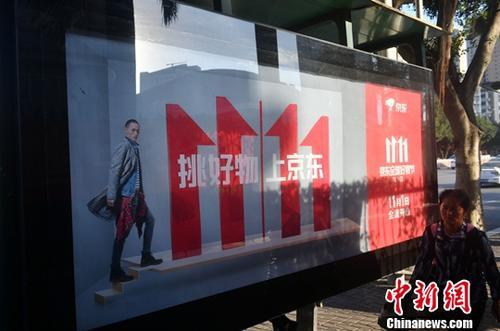 資料圖：11月1日，福州民眾從雙十一廣告牌前經(jīng)過。中新社記者 呂明 攝
