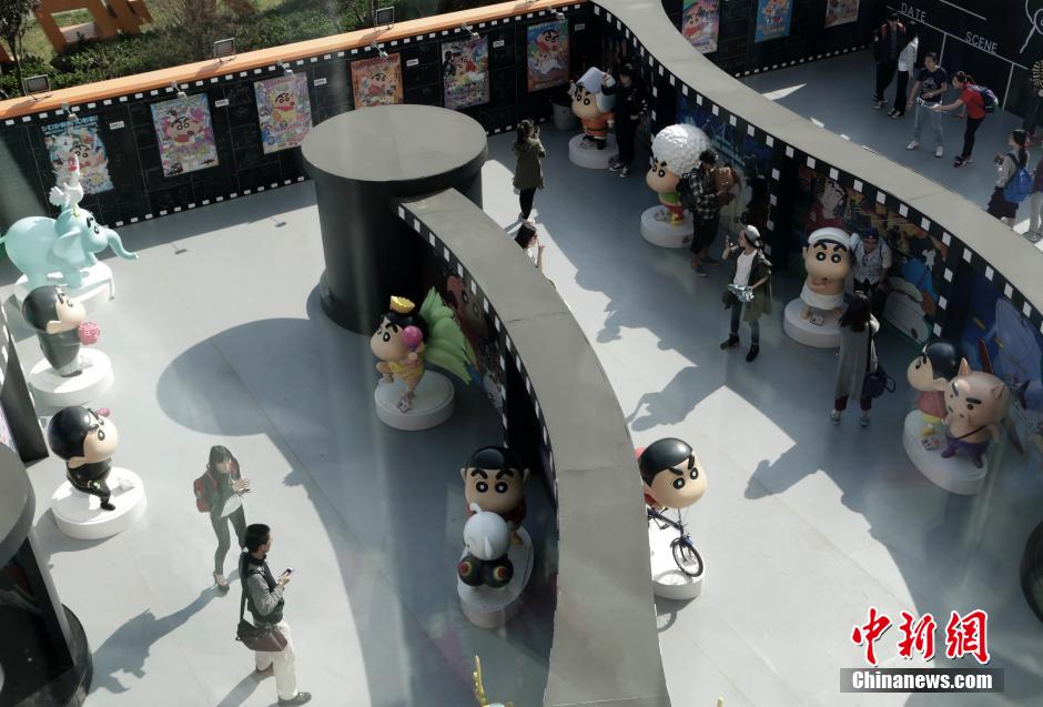 4月22日，游客與蠟筆小新合影。“蠟筆小新25周年紀念特展”日前在北京開展，吸引了不少市民游客。