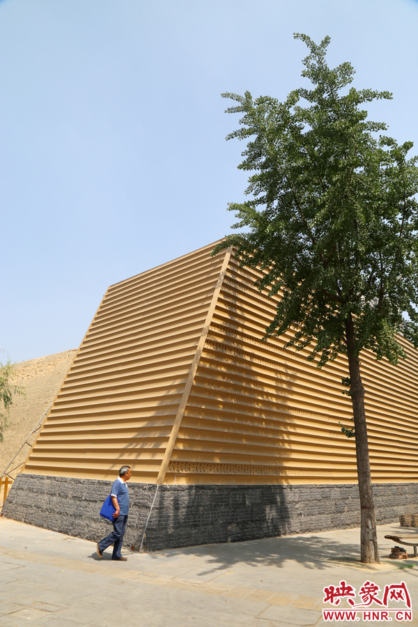 一名路人從“土豪金”保護殼前經(jīng)過。