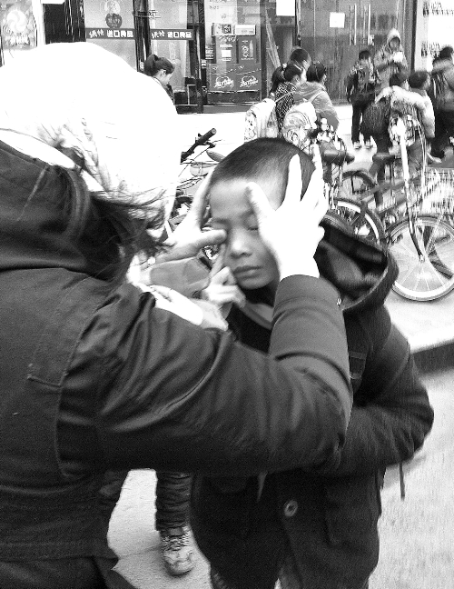 春天風(fēng)沙大，一孩子被風(fēng)沙瞇了眼